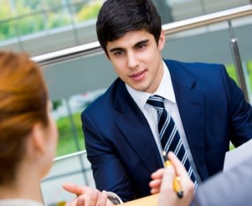 Portrait of confident businessman sharing his ideas with associates at meeting